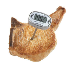 pork chop with a meat thermometer stuck inside