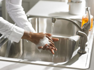 chef washing hands using soap